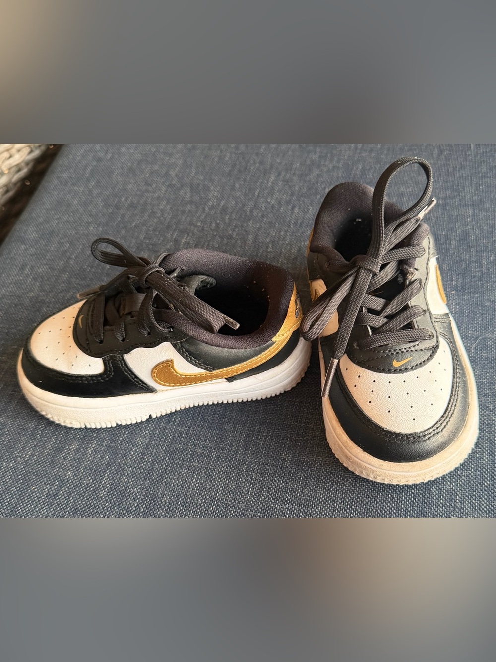 Nike Toddler’s Black and White Sneakers with Gold Swoosh
